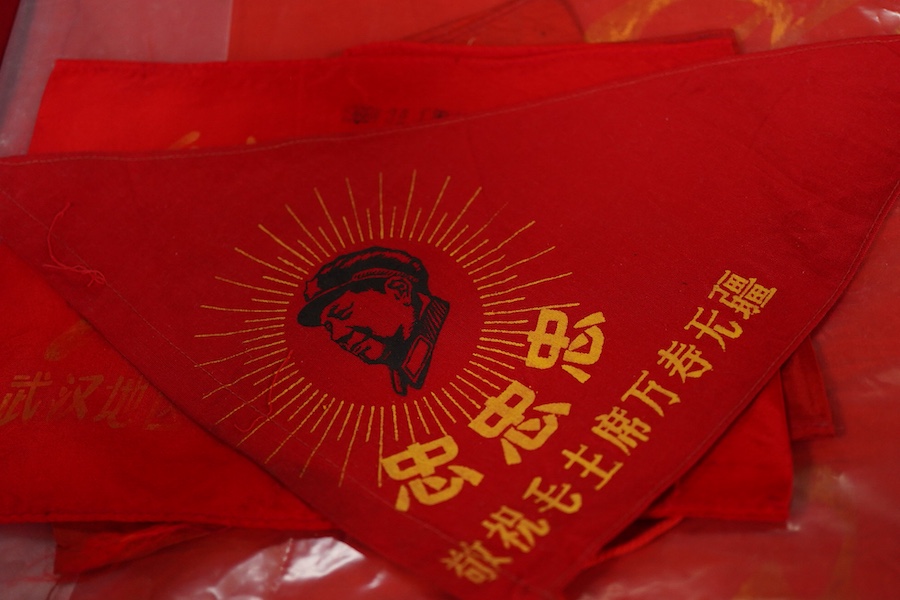 A Chinese Cultural Revolution flag, three armbands, a red book, a badge and a small flag-85cm wide x 102cm long